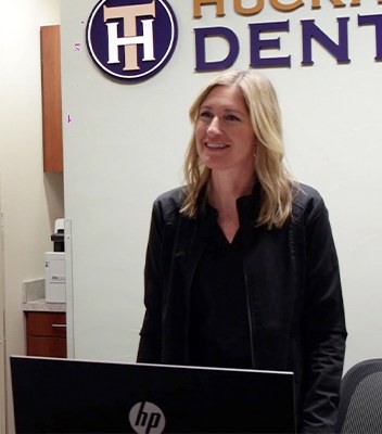 Huckabee Dental team member smiling at front desk