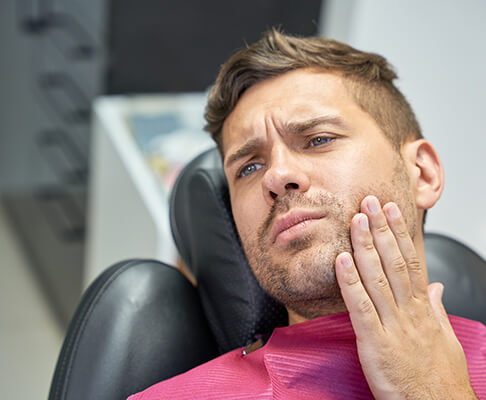 Man with a toothache at the dentist