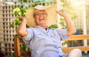 Older woman sitting on a bench having a great time in the sun